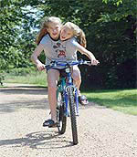 Abby and Brit ride a bike